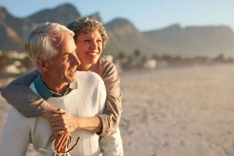 Senior couple enjoying their vacation at the beach | North Houston Hearing Solutions